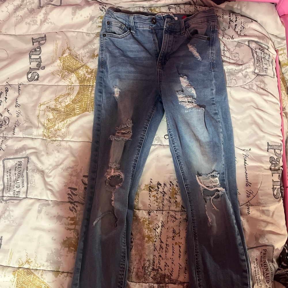 Ripped skinny jeans worn